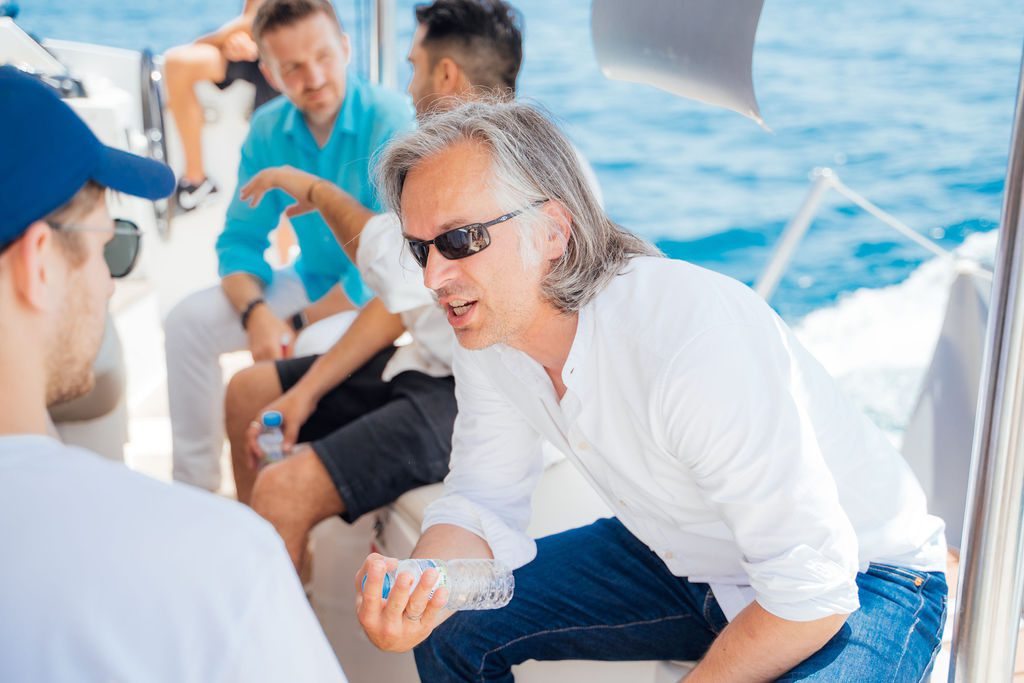 Friends and peers laughing on deck at a past GrowBoat sailing