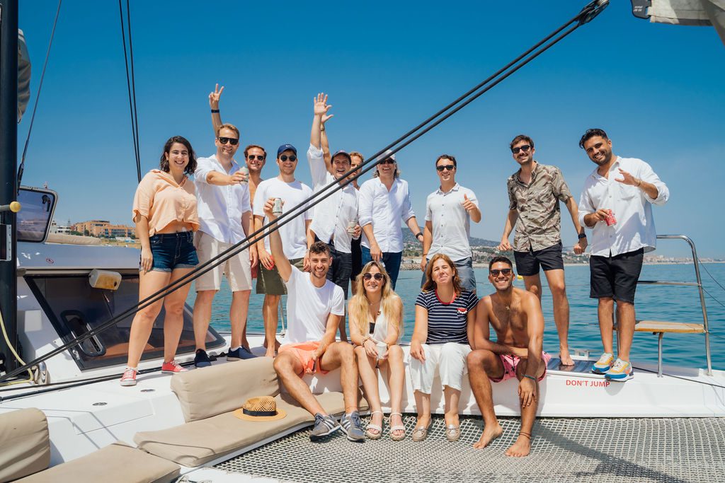 Friends and peers laughing on deck at a past GrowBoat sailing