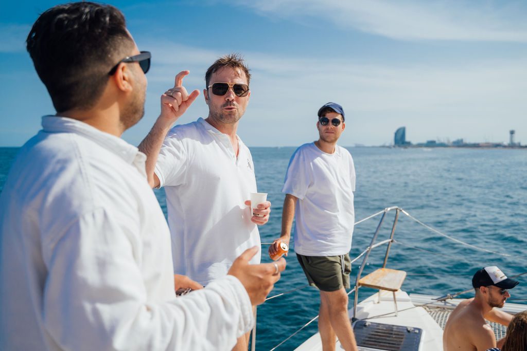 Friends and peers laughing on deck at a past GrowBoat sailing