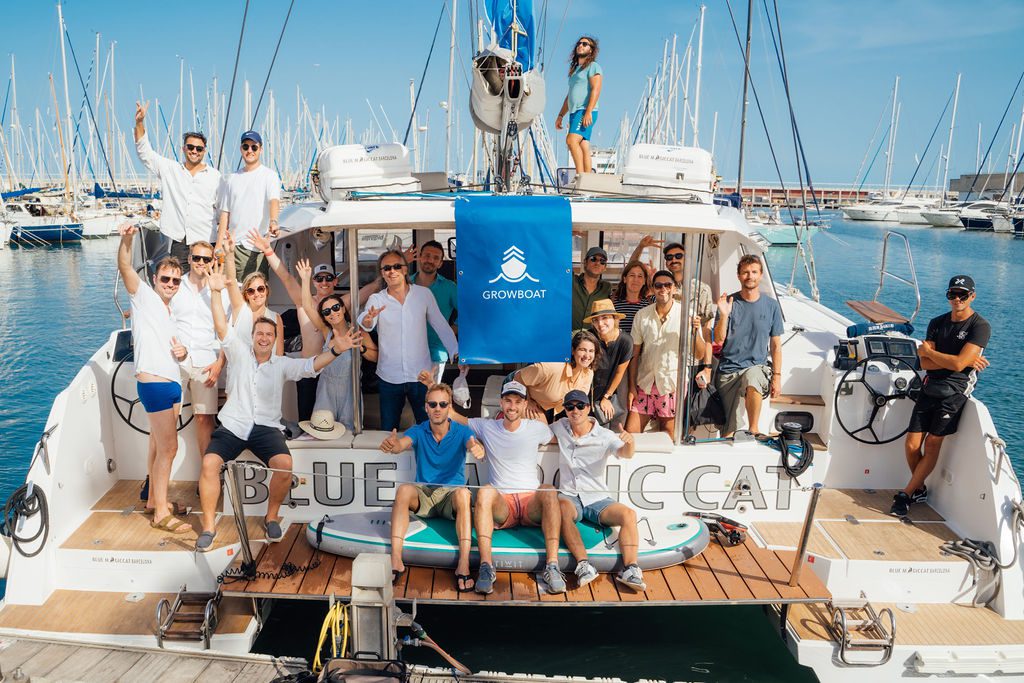 A small group in conversation aboard the GrowBoat catamaran