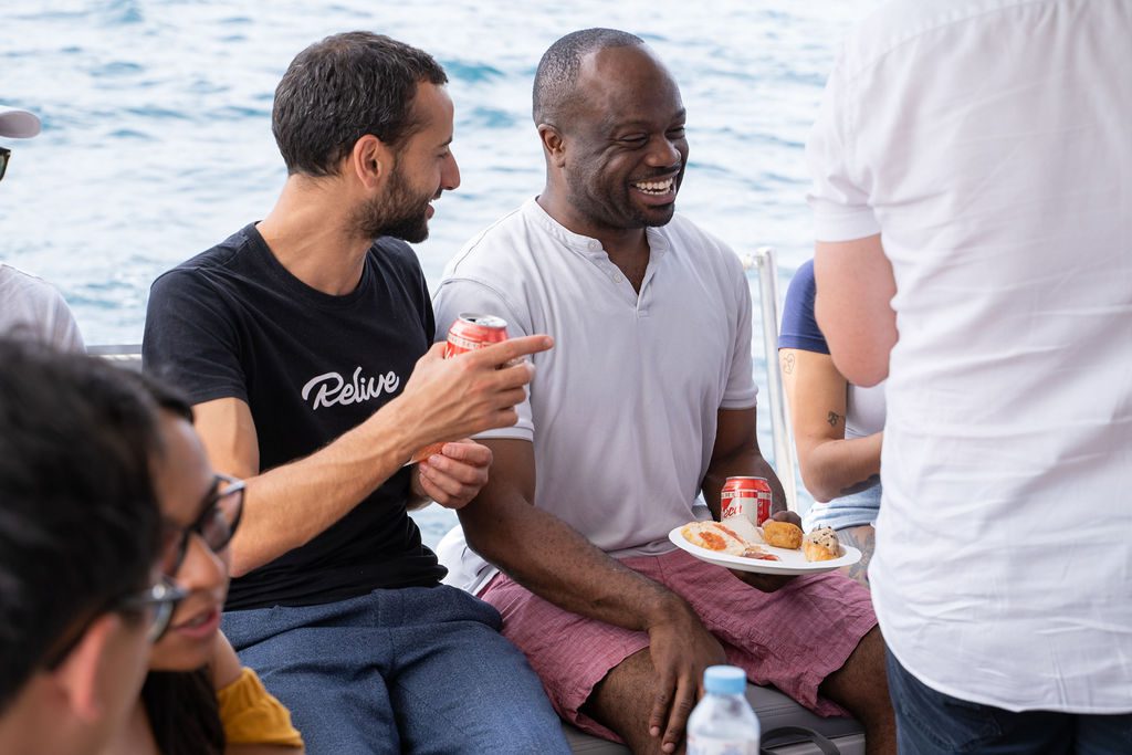GrowBoat guests in conversation on the catamaran deck