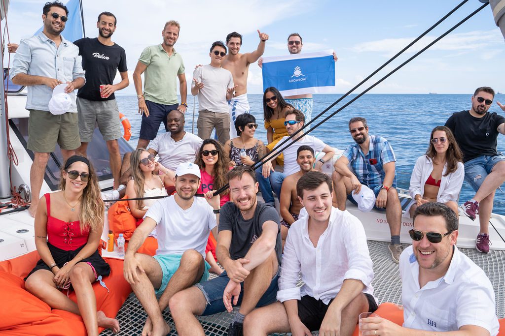 GrowBoat guests in conversation on the catamaran deck