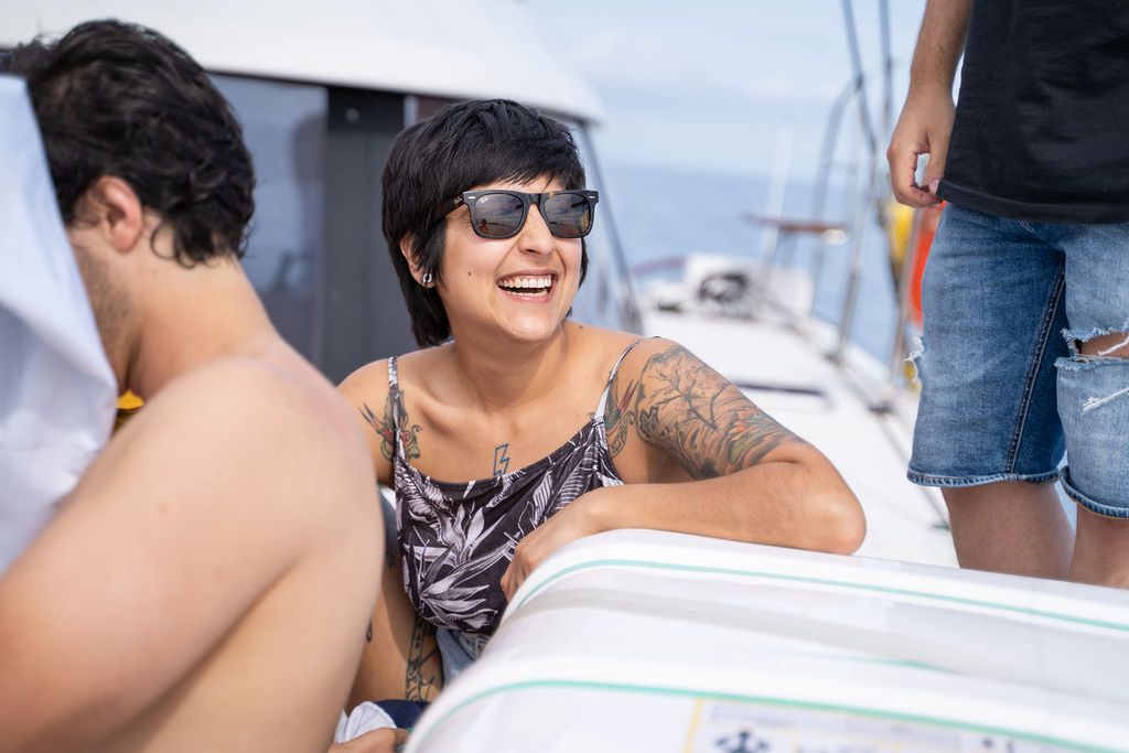 A small group in conversation aboard the GrowBoat catamaran