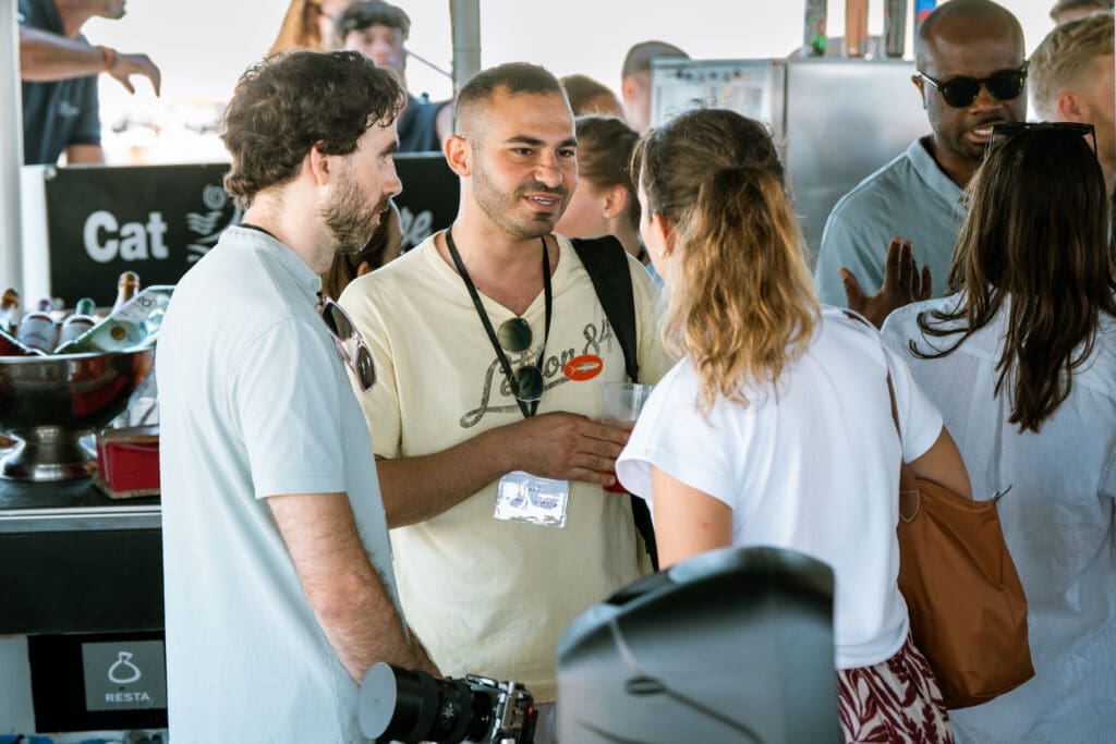 GrowBoat Barcelona guests gathered on the bow of the sailing yacht