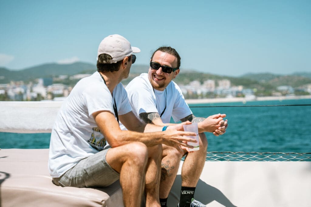 Guests exploring the Barcelona coastline aboard the GrowBoat sailing yacht
