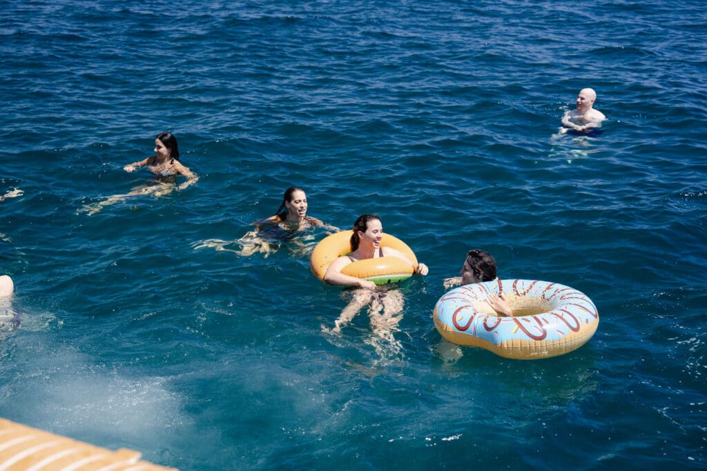 Guest diving off the bow of the GrowBoat yacht into the Mediterranean