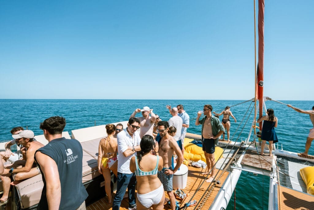 Guests stepping aboard the GrowBoat yacht at the Barcelona marina