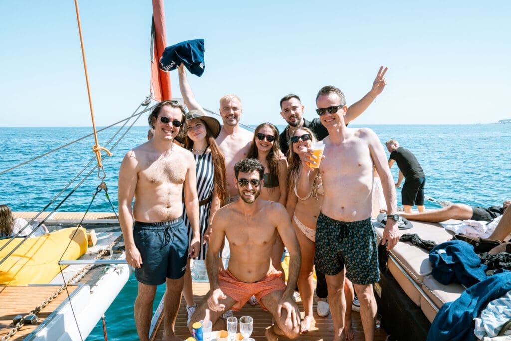 GrowBoat Barcelona attendee leaning on the yacht rail with the sea behind