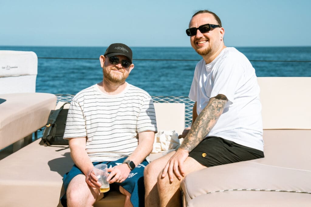 Candid networking moment aboard the GrowBoat sailing yacht in Barcelona