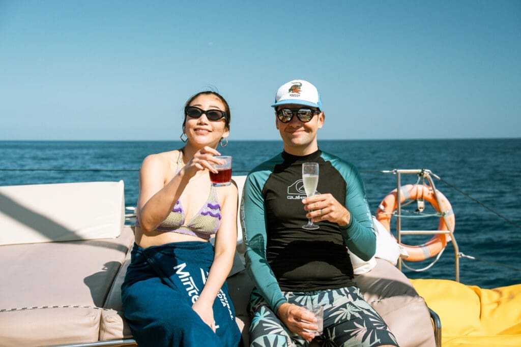 GrowBoat guests enjoying the catering spread on the yacht deck