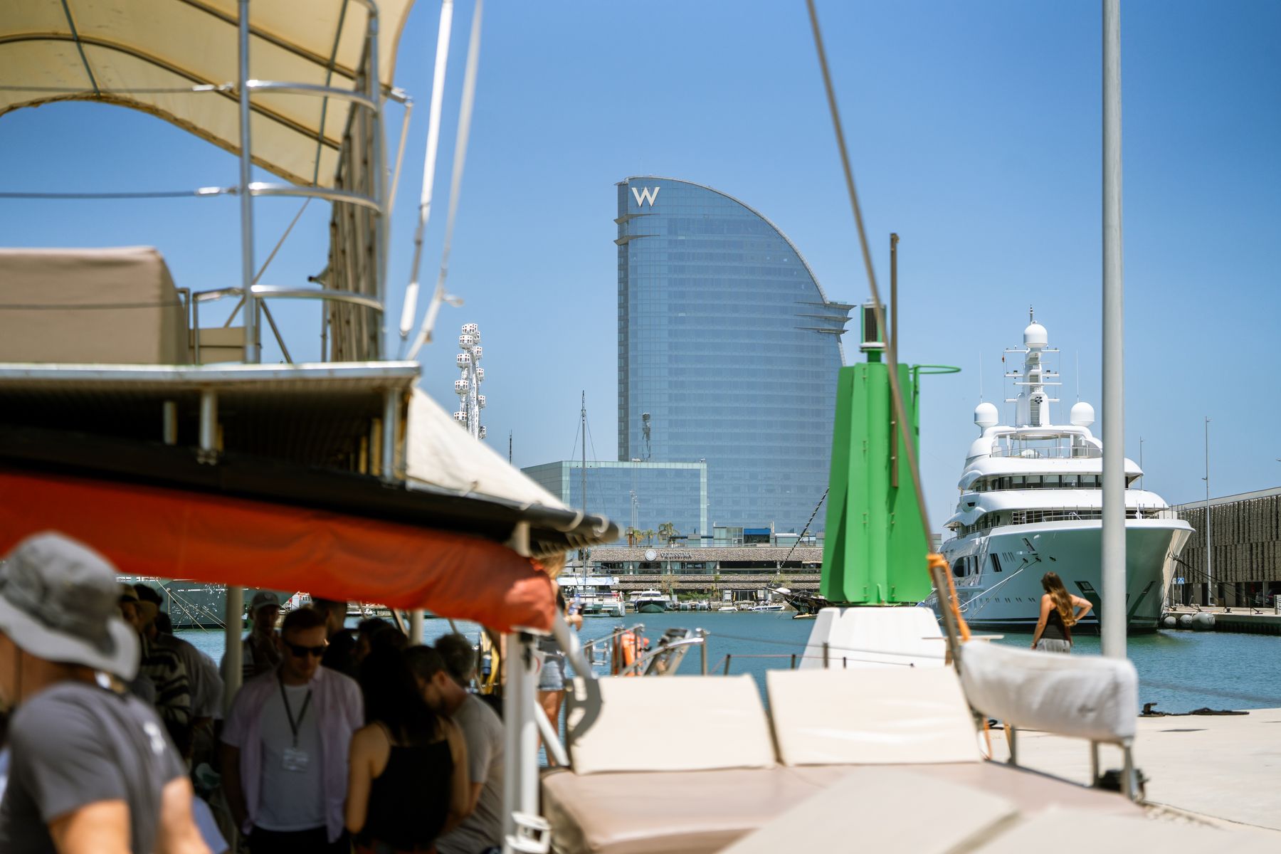 GrowBoat guests in conversation on the catamaran deck off Barcelona