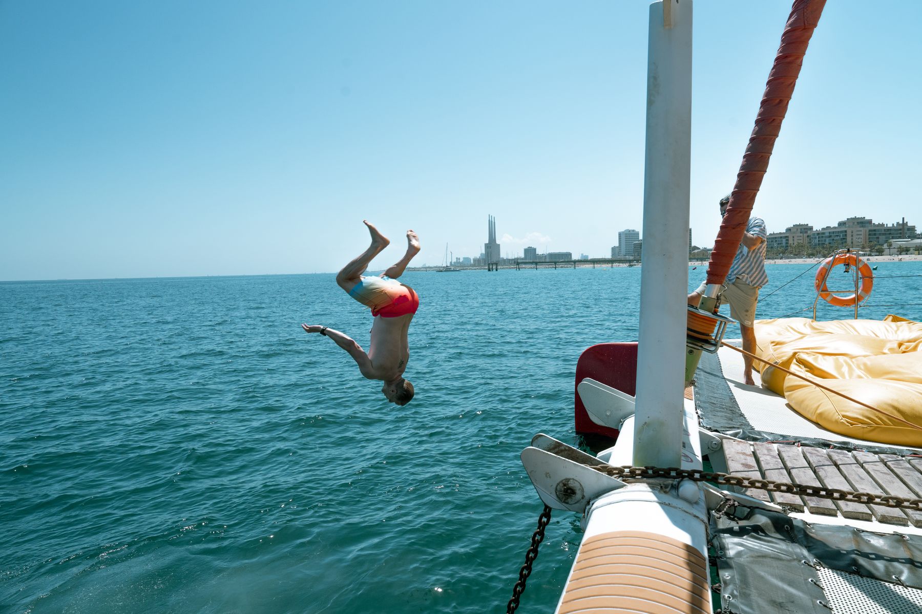 GrowBoat guests in conversation on the catamaran deck off Barcelona