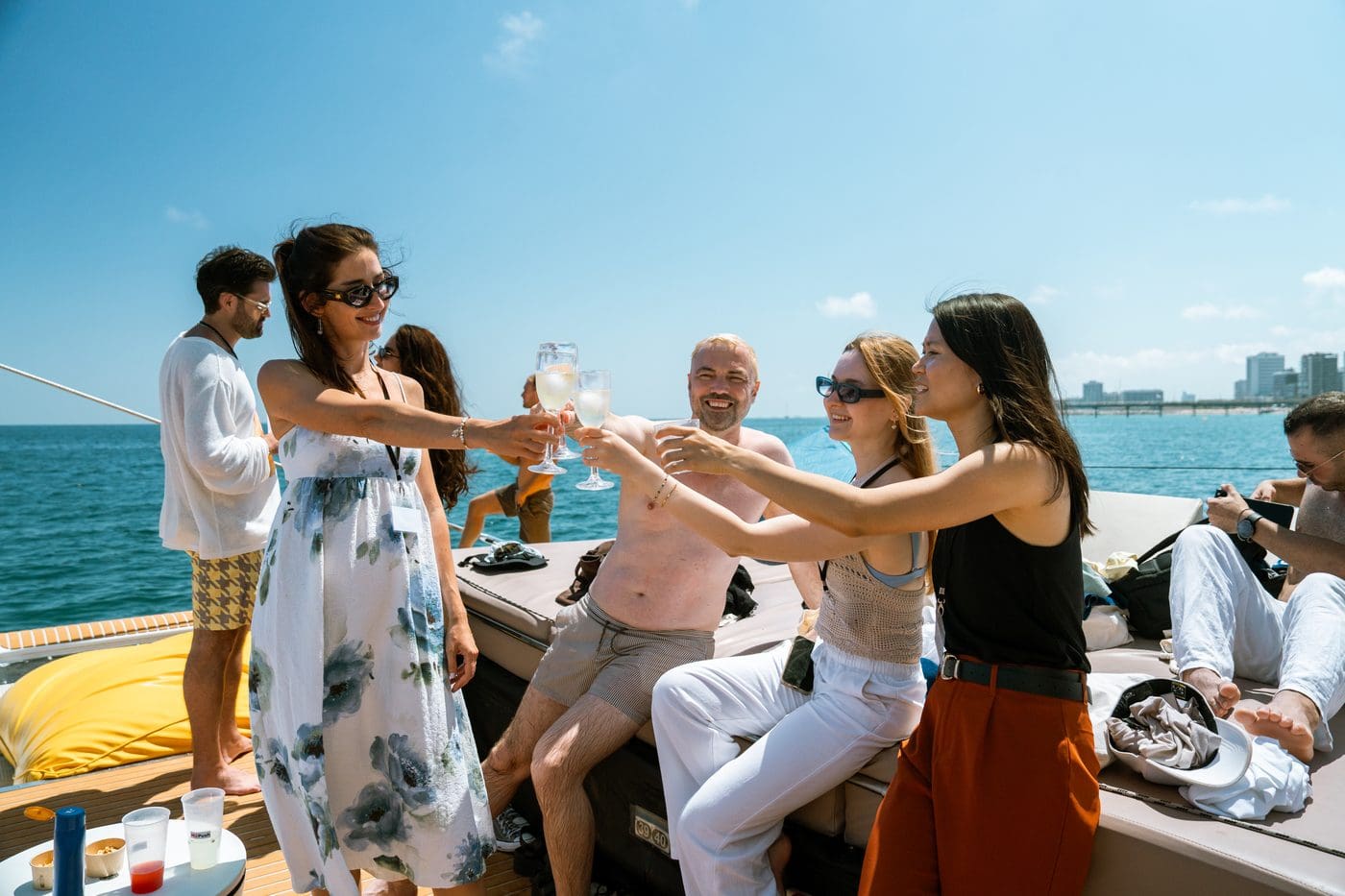GrowBoat guests raising a toast together in golden afternoon light on deck